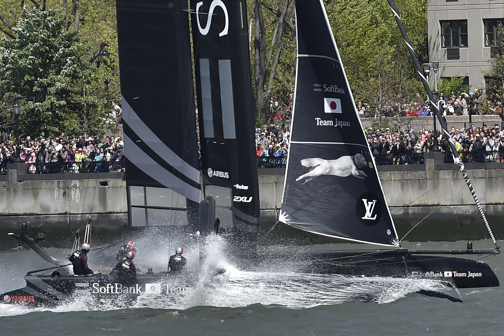 Spectators in Battery Park watch Softbank Team Japan crash through a wave during a Louis Vuitton America's Cup World Series preliminary race in New York City. Photo by David Tulis.                                                                                                 