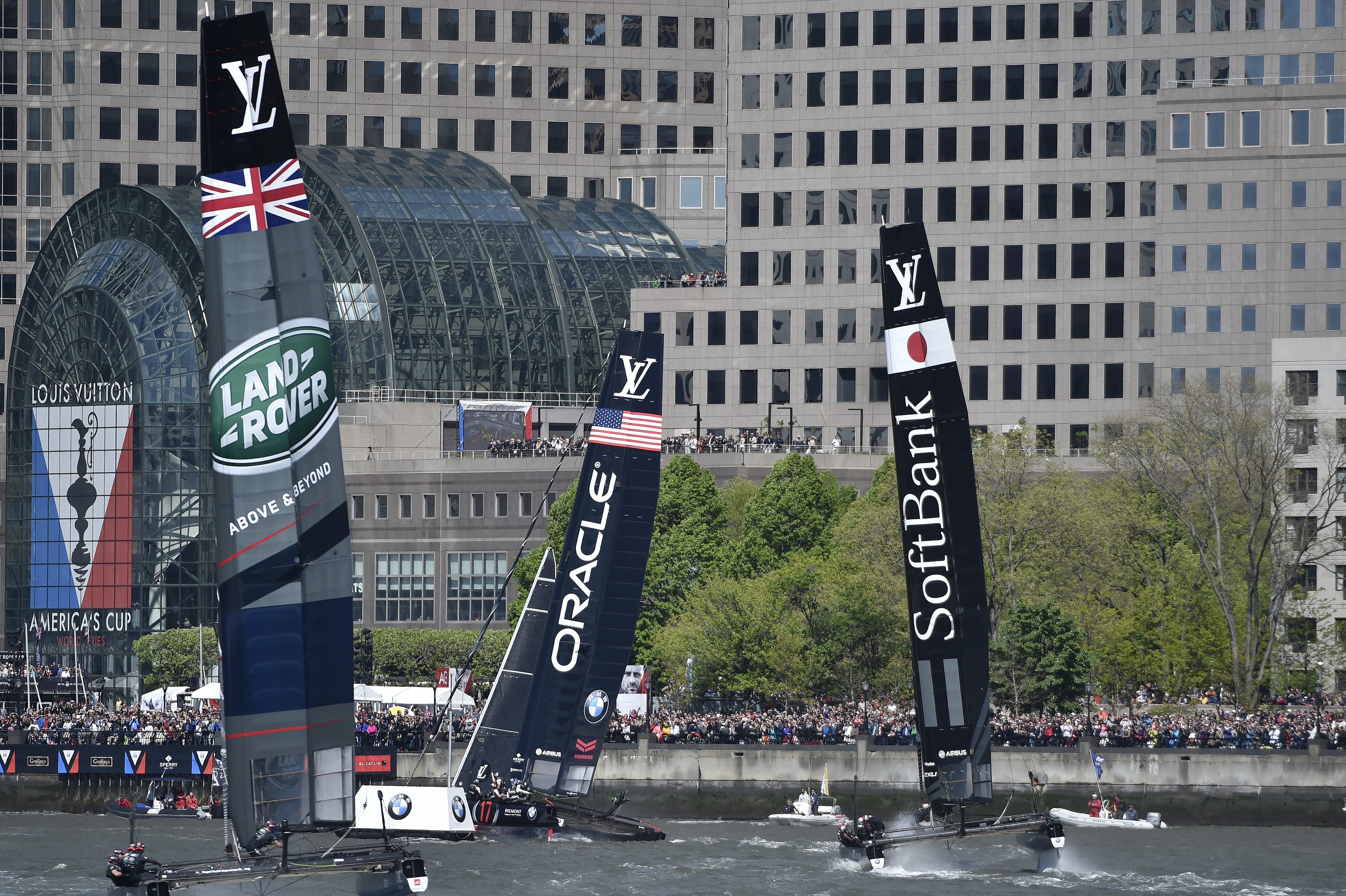 Oracle Team USA leads Softbank Team Japan around a buoy during a Louis Vuitton America's Cup World Series preliminary race in New York City. Photo by David Tulis.                                                                                                                   
