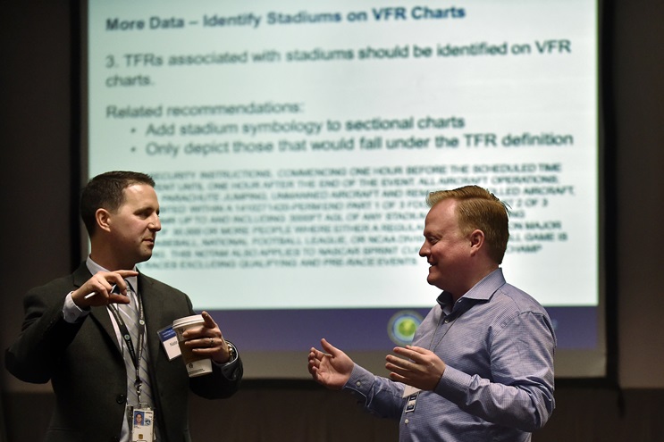 SkyVector flight planner's David Graves, right, and the FAA's Nate Rahm talk during an aviation industry meeting on ways the private sector could use some of the agency's aeronautical data in Washington, D.C., April 29. Photo by David Tulis.