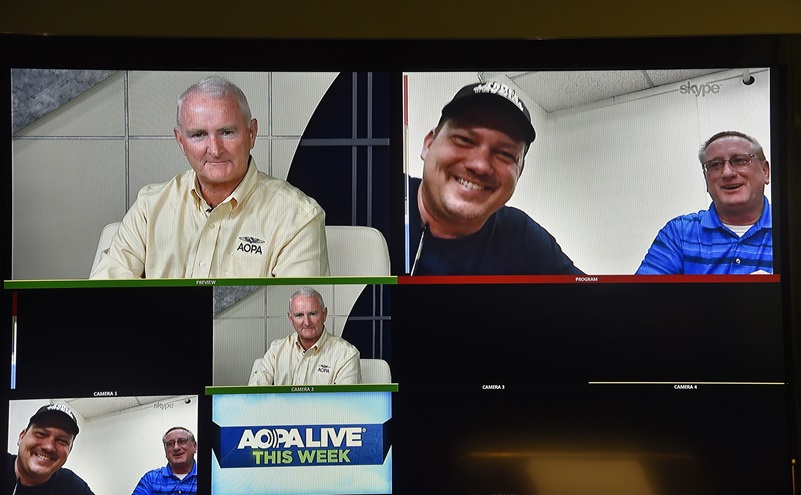 AOPA President Mark Baker awards a Reimagined Cessna 150 to the Nate Abel Flying Club's James Smith and Tom Barry in Texas via live Skype link from the association's headquarters in Frederick, Maryland, Oct. 13. Photo by David Tulis.