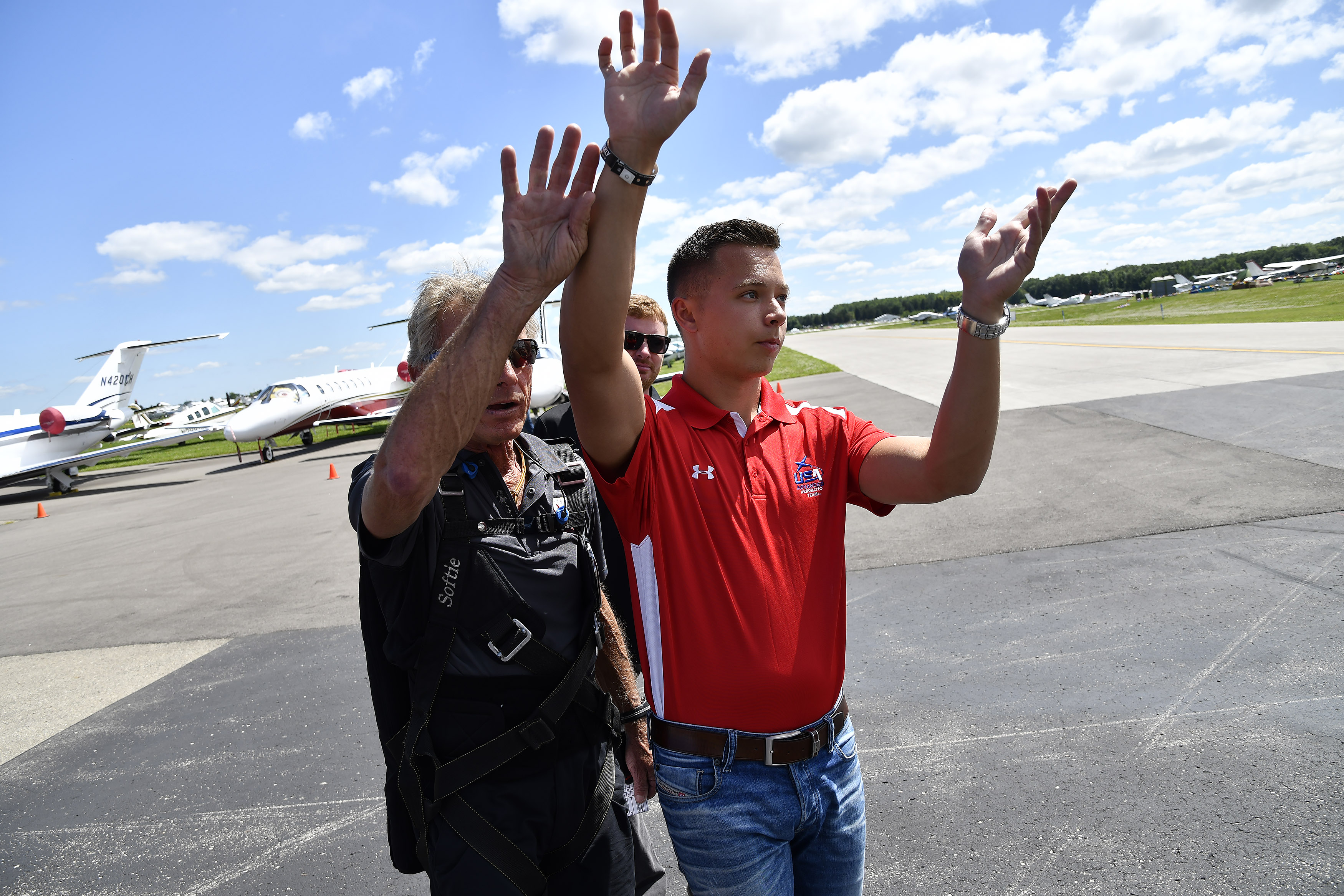 Cameron Jaxheimer, 22, visualizes maneuvers on the ramp with Team Oracle aerobatic performer and mentor Sean D. Tucker during EAA AirVenture. Photo by David Tulis.