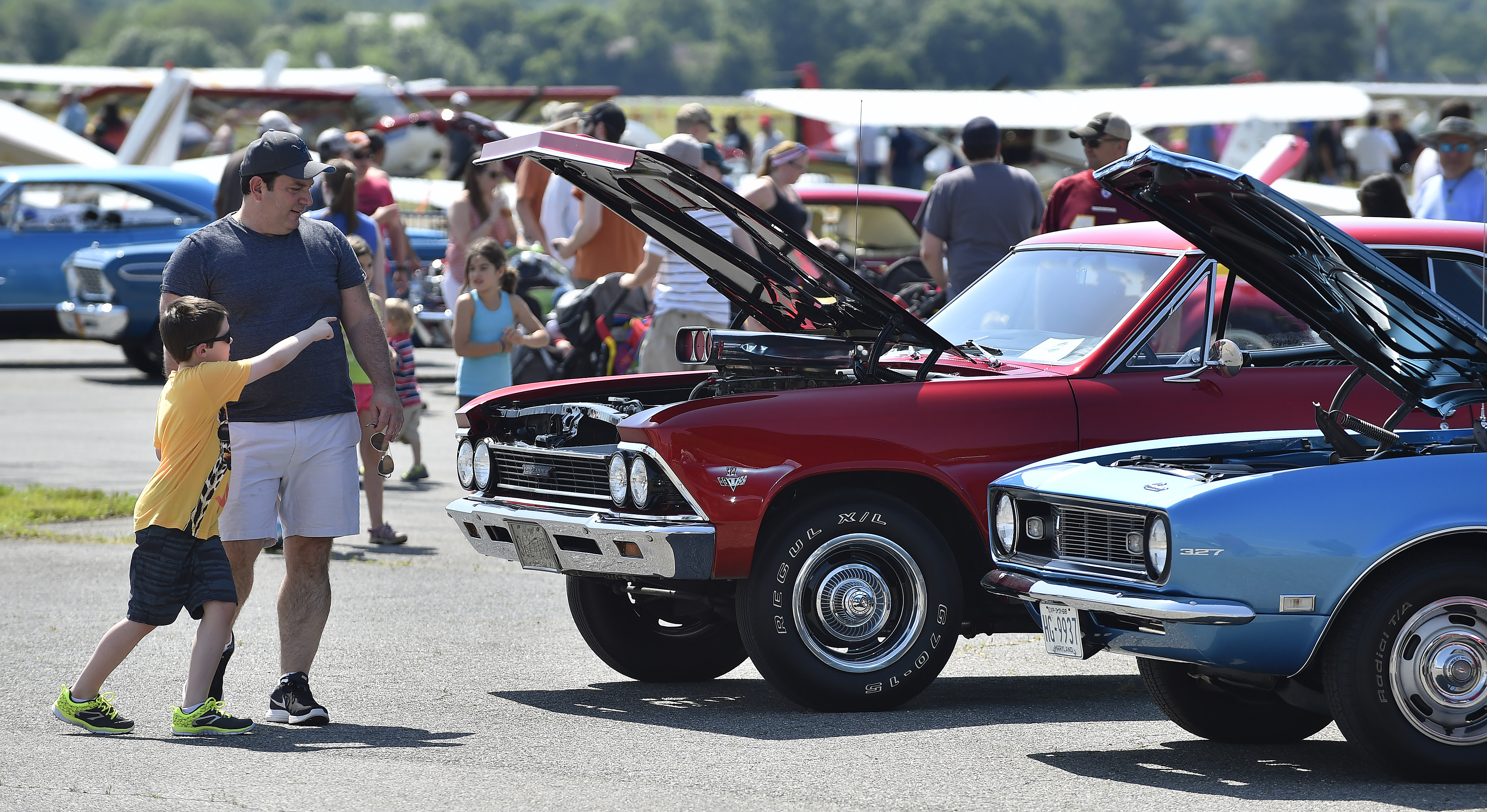 Aviation, automobile, and motorcycle aficionados mingled with historic aircraft, custom and classic autos, and unique motorcycles during the Wings 'n Wheels event. Photo by David Tulis.