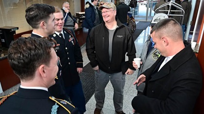 General aviation pilot Karl Hoffman speaks with military members after coordinating a flight of three aircraft during Patient Airlift Services missions for the Army-Navy football game in Philadelphia, Dec. 8. Photo by David Tulis.