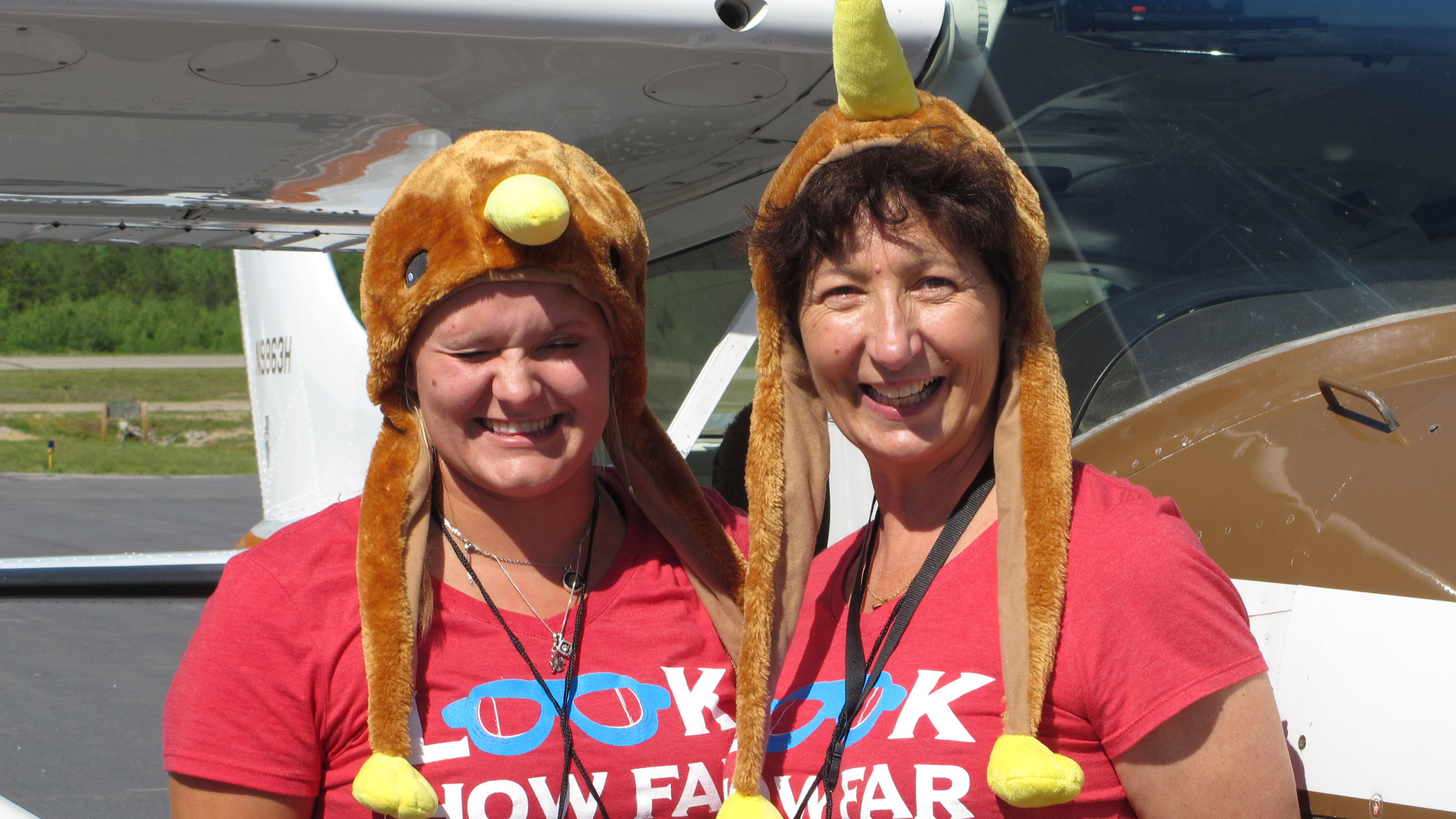 Kiwi Express team members McKenzie Krutsinger (left) and Dee Bond dropped their serious pilots’ mien to pose for a photograph beside their Cessna 182 after completing the Air Race Classic with a landing at Eastern Slope Regional Airport in Fryeburg, Maine, on June 21. Photo by Dan Namowitz.