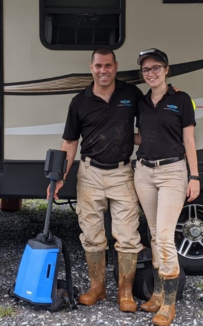 Nir and Amanda Pe'er clearly don’t mind getting their hands dirty in their efforts to push their droning and scanning to the limits. Here, they are seen with a backpack lidar unit that also records 360-degree video. Photo courtesy of Inspired Intelligence.