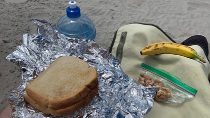 A peanut butter and jelly sandwich, banana, and zip-close bag of unsalted cashews make a yummy picnic lunch for the beach. Photo by Paul Harrop.