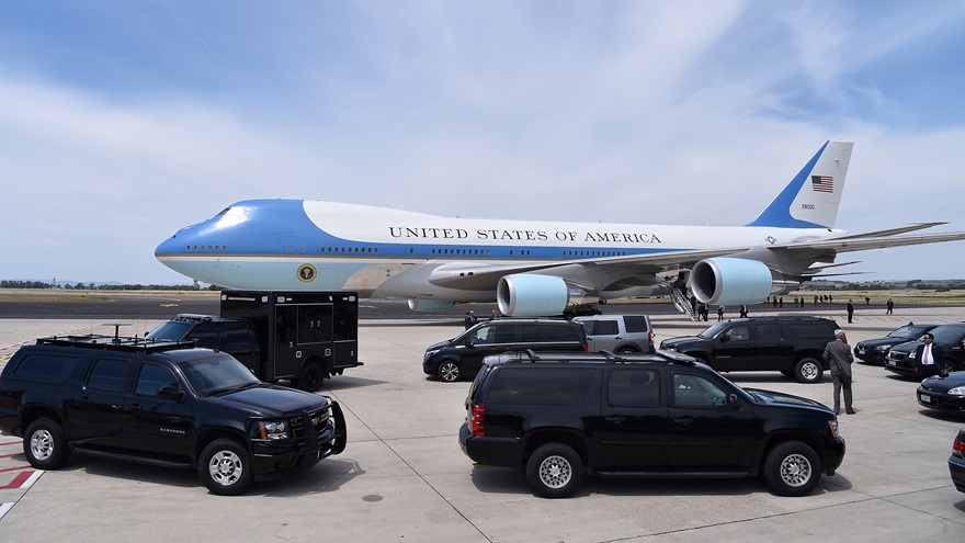 Security vehicles are seen in front of Air Force One, a modified Boeing 747. Photo by Alberto Lingria, REUTERS.