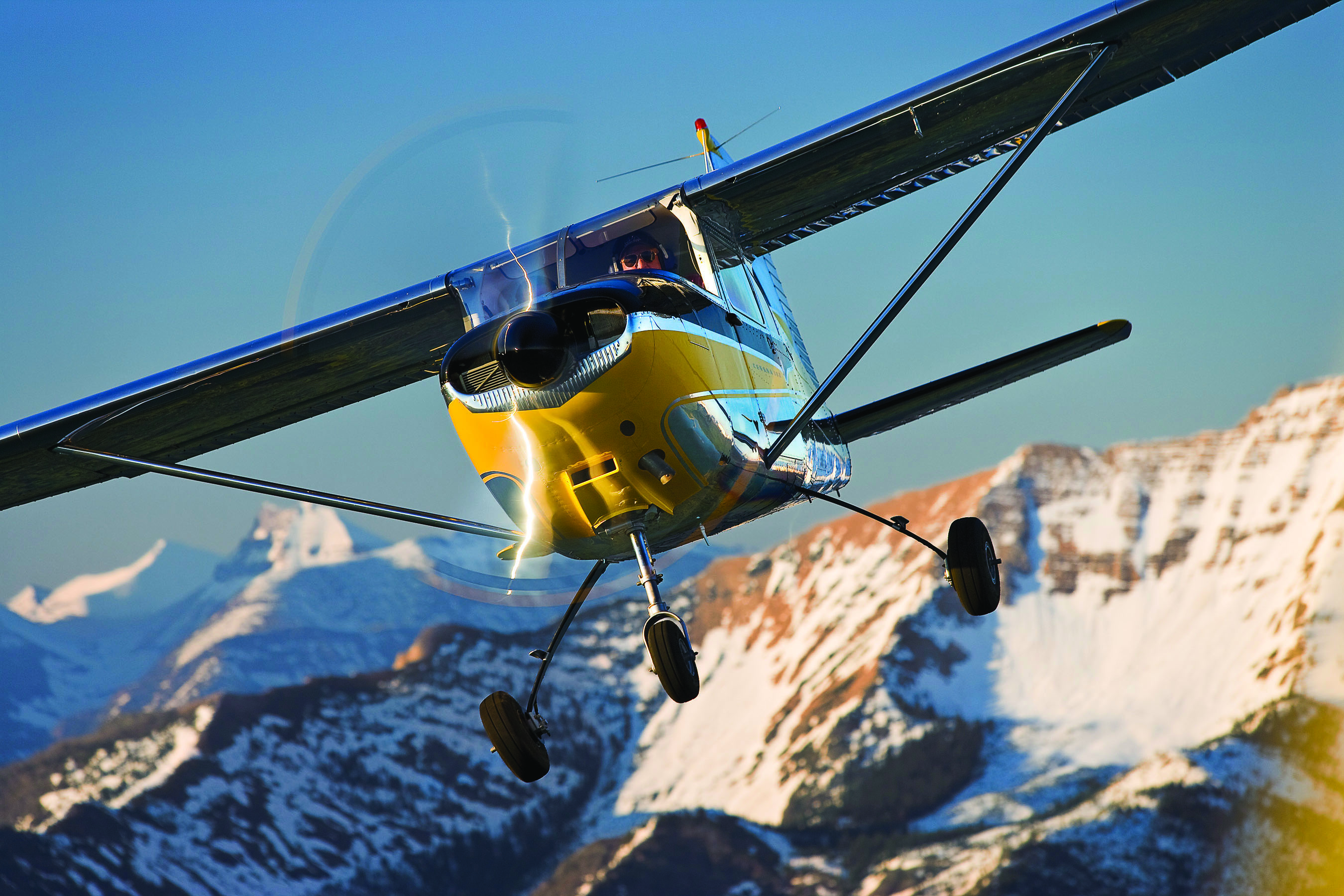 The first production Cessna 182 shows off over Montana's Glacier National Park. The long and spindly landing gear legs were shortened in subsequent models to make it easier to climb in and out of the cabin.