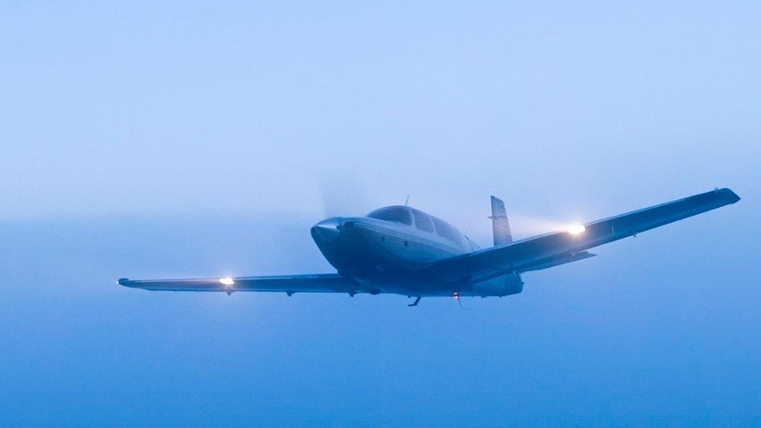 plane flying in a hazy fog