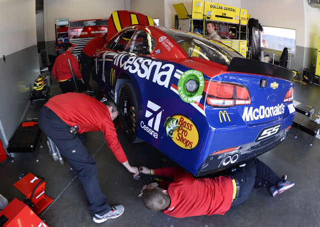 Crew members prepare NASCAR driver Jamie McMurray's No. 1 McDonald's/Cessna Chevy for Daytona 500 qualifying at Daytona International Speedway in Daytona Beach, Florida, Feb. 14, 2016. Photo by David Tulis.