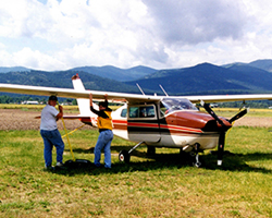 From his home airport in Roundup, Mont., State Sen. Kelly Gebhardt flies out over the Rocky Mountains and the plains. Shown here with his Cessna 210 and twins Derin and Donna at Plains, Mont., in 1998.