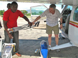 At the end of the day, Pelletier, second from left, talks with other pilots on the ramp at Jacmel, Haiti.