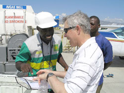Dennis Pelletier, right, finds fuel at Port-Au-Prince.