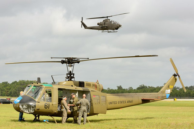 AAHS crew ready the Huey for its next flight as the Cobra approaches for landing. 