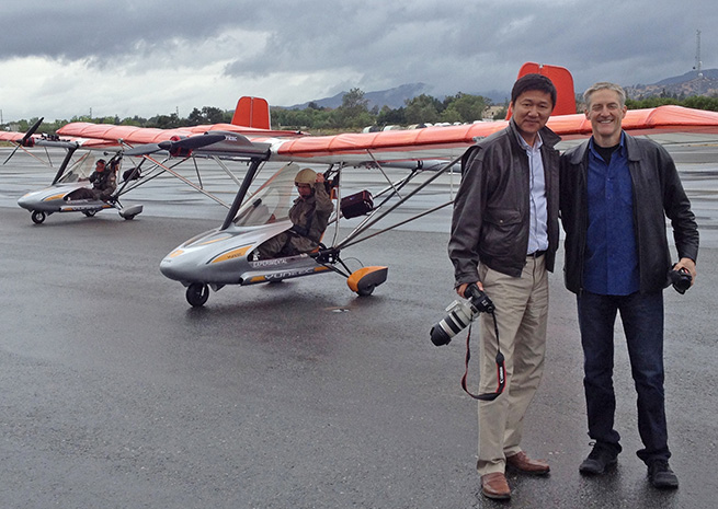 Erik Lindbergh and GreenWing International CEO Tian Yu stand in front of two all-electric eSpyders preparing to give an airshow performance at EAA AirVenture 2013. GreenWing International photo courtesy Dan Johnson.