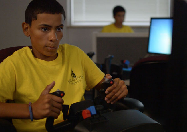 A Bridge Partnership student practices on a simulator.