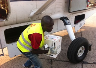 Supplies are unloaded after a Mission Aviation Fellowship flight. Photo by MAF's Nick Frey.