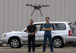Two men operate an unmanned aircraft system (drone) with permission at the Tullahoma, Tennessee, airport. Photo by David Tulis/AOPA.