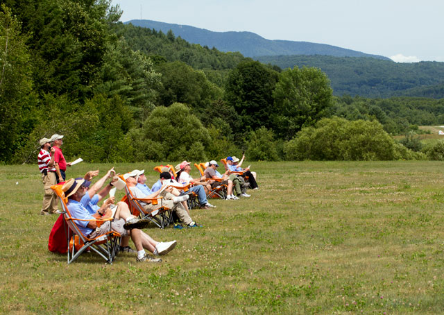 Judges, assistants, and score recorders sit on the line grading flights at the Green Mountain Aerobatic Contest in July.