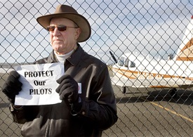 Paul Coward of Oxford holds up a Protect Our Pilots sign during a press conference with local pilots and state officials protesting the proposed Towantic Energy Center at Oxford Airport in Oxford in December. Photo by Steven Valenti, courtesy of the Republican-American, Waterbury, Connecticut.