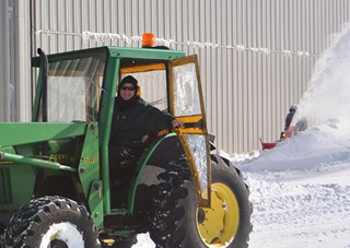 Marshfield Municipal Airport Manager Dave Dineen smiles while he moves snow. Photo by Ann Pollard, Shoreline Aviation Inc.