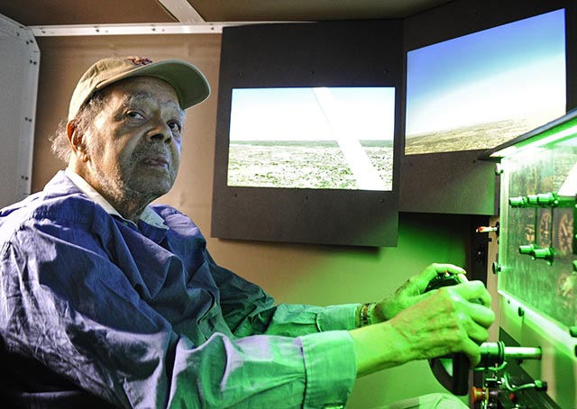 World War II Tuskegee Airman Lt. Floyd Collins, who trained in Mustang P-51 airplanes at South Dakota's Rapid City Army Air Base, concentrates on flying a Redbird FMX flight simulator at the Montgomery County Airpark. Photo by David Tulis/AOPA.