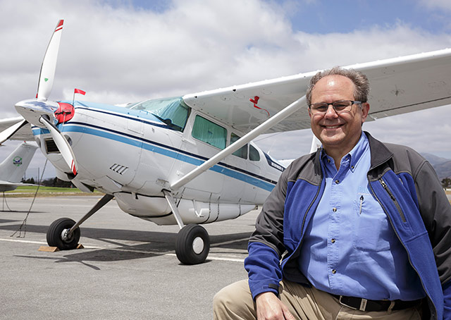 John Kounis with the Cessna 185 he ferried to Malaysia.