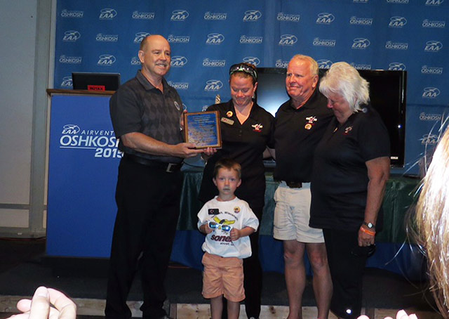 Dan Johnson, left, presents the LAMA President's Award to the family of Jeremy Monnett of Sonex.