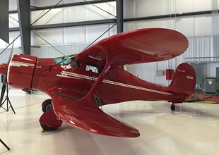 Aero Mark owner Bob Hoff’s D17S Staggerwing served as the podium backdrop.