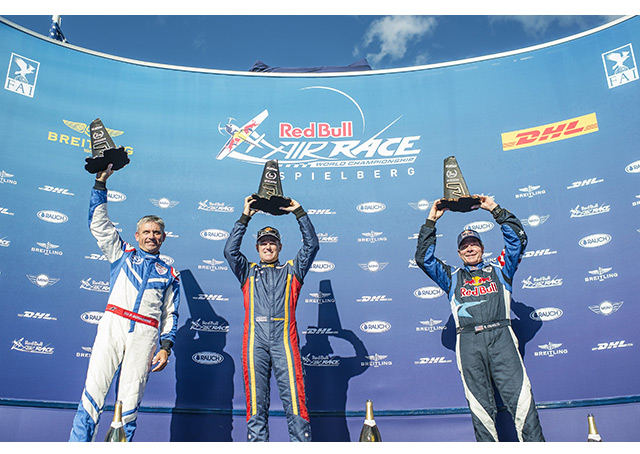 Kirby Chambliss, right, joins Austria Red Bull Air Race winner Matt Hall, left, of Australia, and second-place winner Paul Bonhomme of England on the podium. Chambliss placed third.. Photo by Joerg Mitter/Red Bull Content Pool.