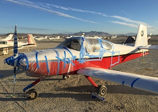The author's RV-10 is covered in plastic wrap and sealed with blue tape to ward off the Nevada desert's blowing sand at Black Rock City Municipal Airport. Photo by Dave Hirschman/AOPA
