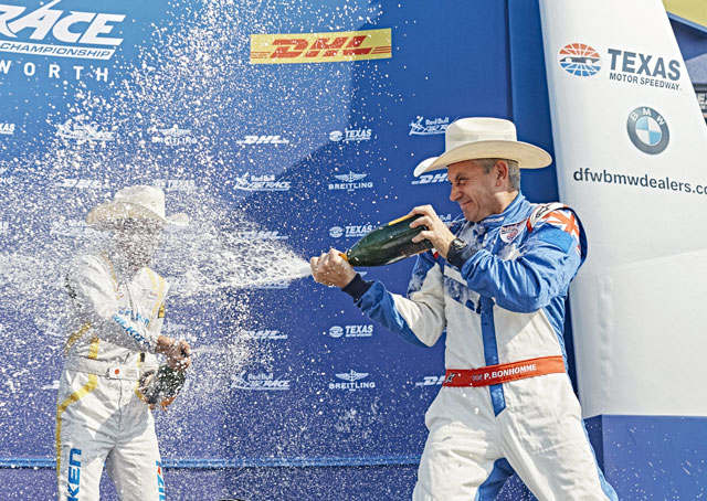 Paul Bonhomme of Great Britain (right) and Yoshihide Muroya of Japan celebrate during the Award Ceremony of the seventh stage of the Red Bull Air Race World Championship at the Texas Motor Speedway. Photo by Balazs Gardi/Red Bull Content Pool.