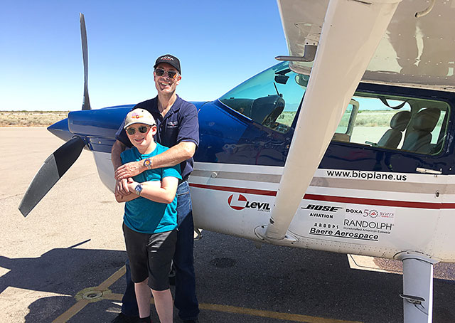 Ross McCurdy and his son, Aedan, in front of the Cessna 182 bioplane they flew across the United States. Photo courtesy of McCurdy.