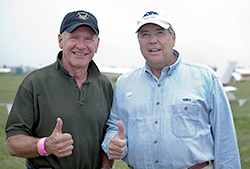 AOPA President Craig Fuller (right) accepts a pledge by pilot and actor Harrison Ford to broaden his role in AOPA&rsquo;s GA Serves America campaign.