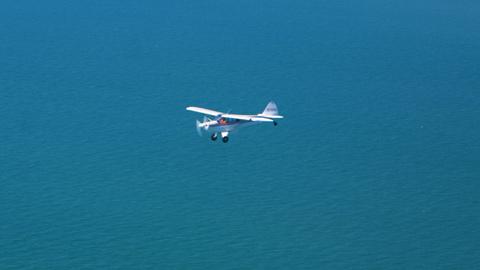 Recreational Aviation Foundation Director Tim Clifford flies his Husky in formation with the others down the coast.