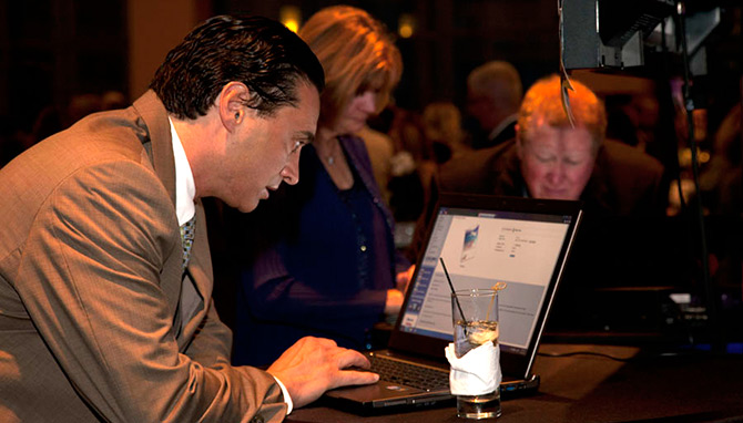 Bidders browse the wide array items for A Night for Flight auction
