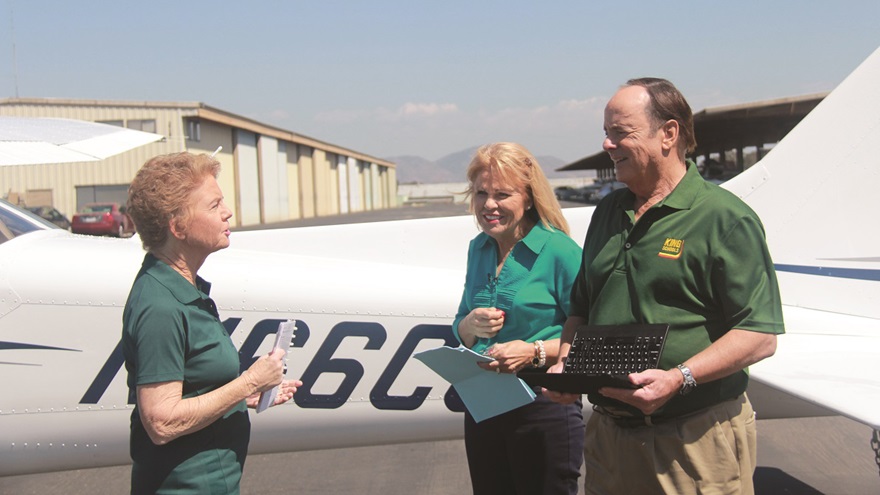 Martha King, left, talks with Designated Pilot Examiner Mary Schu and John King during production of an updated private pilot test prep course. The course featured John as a private pilot candidate receiving a checkride from Schu. Photo courtesy King Schools.