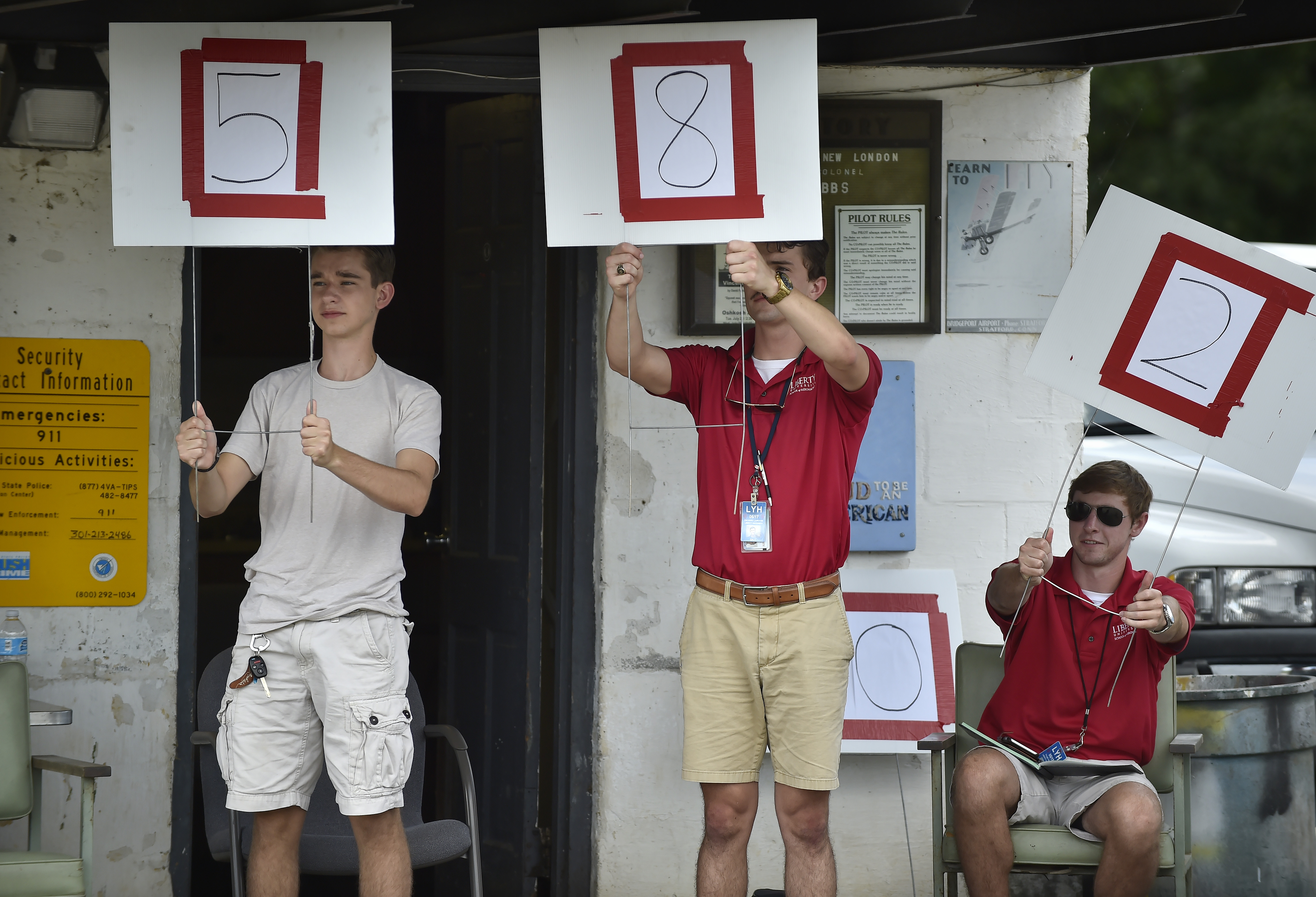 Liberty University flight instructors and fellow solo camp students score landings.
