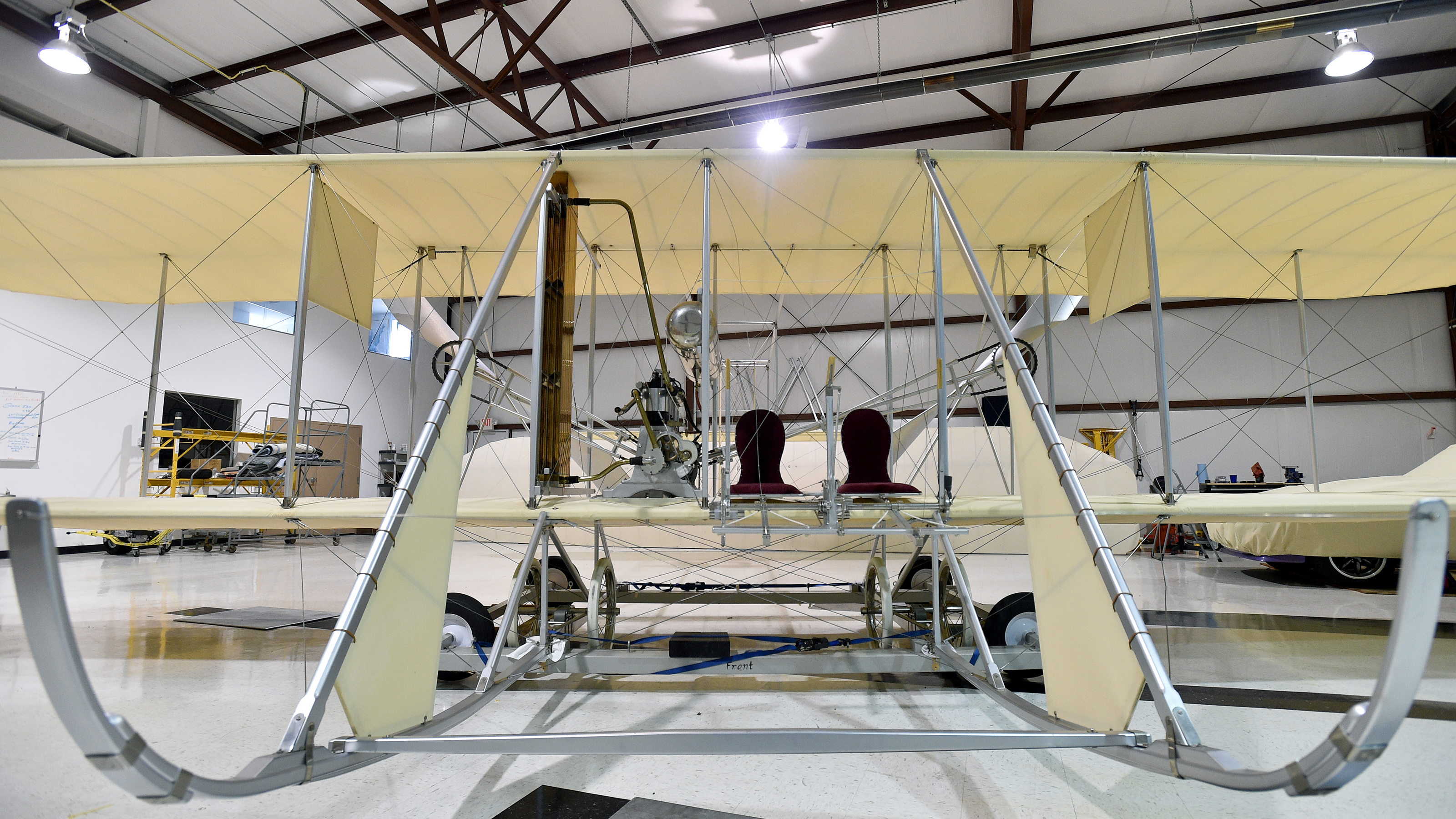 A 1911 Wright Flyer B re-creation shows the ingenuity the Wright brothers deployed to design and build their flying machine. The pilot sits to the outside and a student sits inside, next to the engine. Photo by David Tulis.