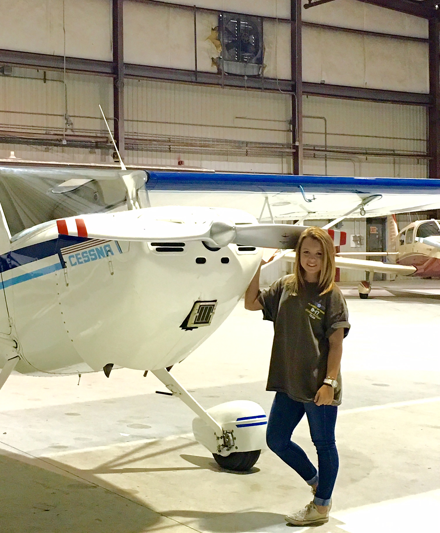 Sierra Lund, who hopes to complete an online degree with Embry-Riddle Aeronautical University, poses for a photo near the Cessna 140 her dad bought her for high school graduation. Photo courtesy of Kevin Lund.                                                                                                                                    