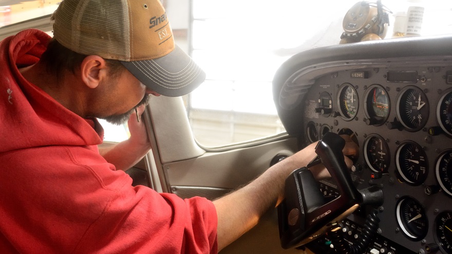 Lancaster Avionics technician Scott Kuhns installs a FreeFlight Systems UAT control head in a Cessna 172. The UAT will provide both ADS-B Out and In capabilities. Photo by Mike Collins.