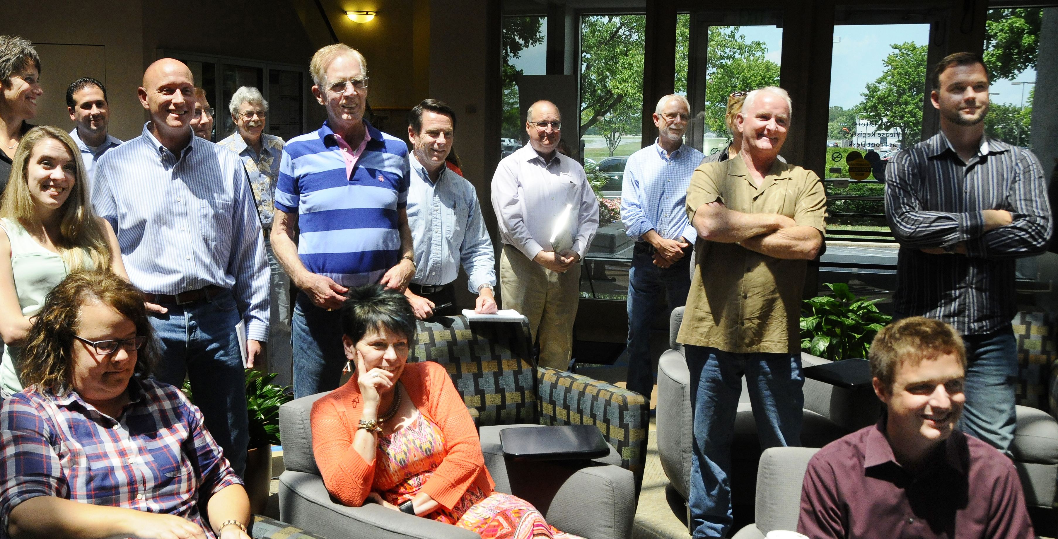 AOPA staff, including President Mark Baker, second right, watch a live television feed of the Senate's vote on FAA reauthorization which includes third class medical reforms for pilots July 13. Photo by David Tulis.