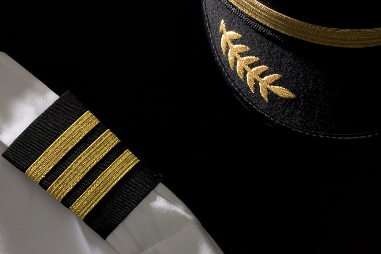 An airline pilot's hat, epaulets, and jacket. Photo by Mike Fizer.


