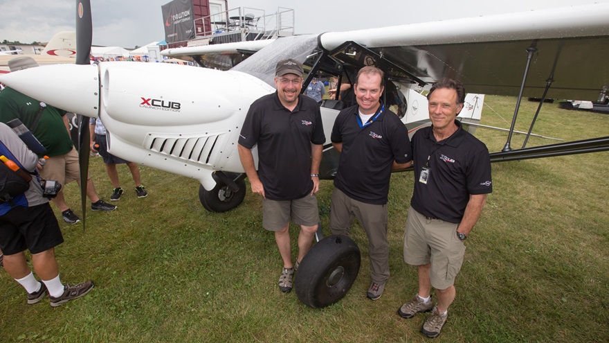 CubCrafters Direct Sales Manager Brad Damm (left) and President Randy Lervold (right) deliver the first XCub to TacAero's Jeremy Young. Photo by Jim Moore.