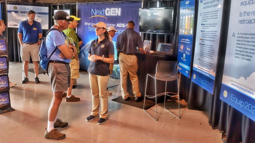 Pilots visit the FAA's NextGen and ADS-B exhibit at EAA AirVenture 2016. Interest in the new technology, required to fly in airspace where a transponder is mandated today beginning in January 2020, is higher than ever. Photo by Mike Collins.