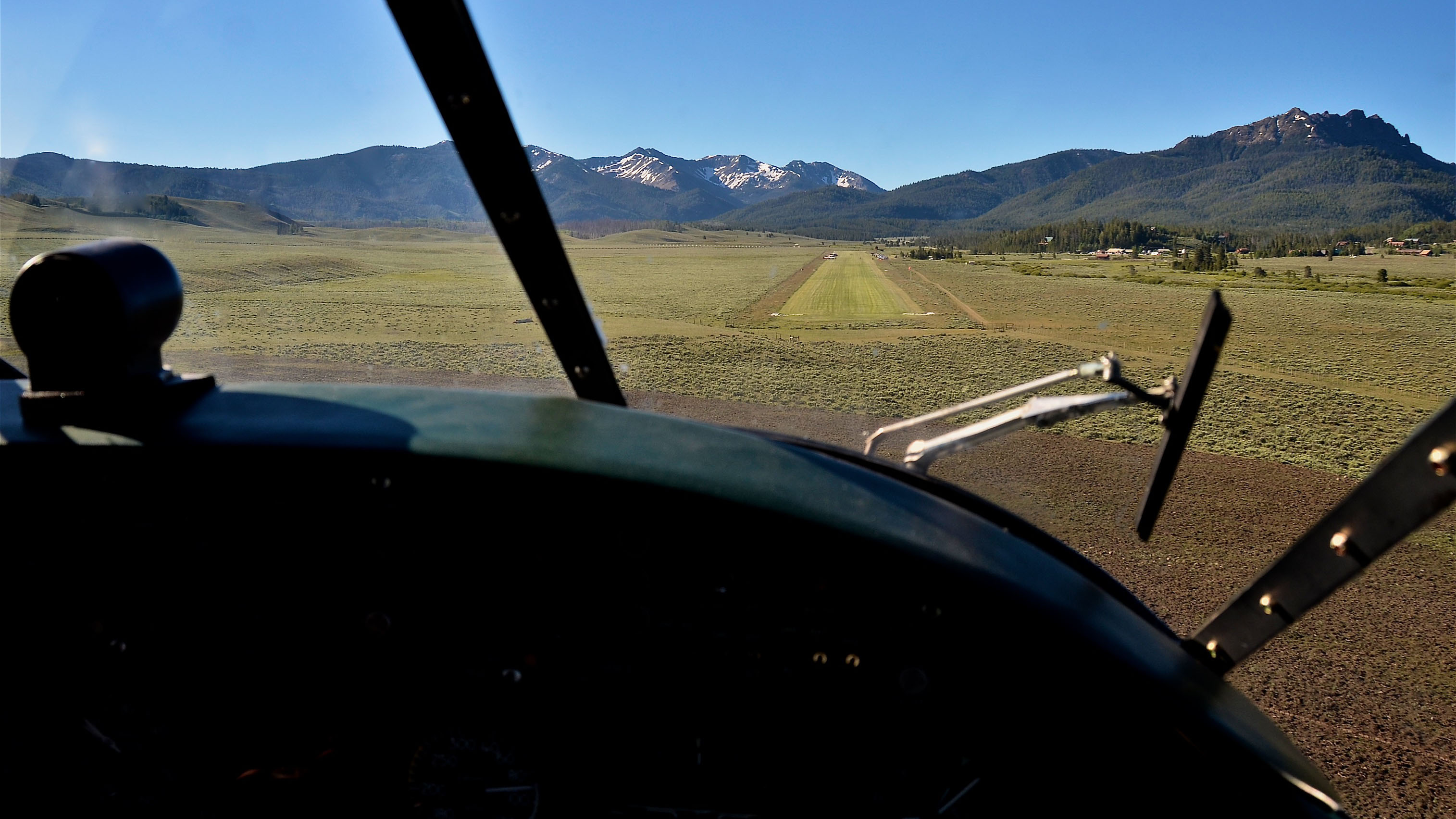 Pilot James Hoff glides his Beech 18 along short final to runway 14 at Smiley Creek. Photo by Chris Eads.
