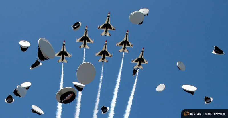 The Thunderbirds perform a flyover as graduates from the Air Force Academy toss their hats in the air at the conclusion of their commencement ceremony in Colorado Springs, Colorado, June 2. Photo by Kevin Lamarque/REUTERS.