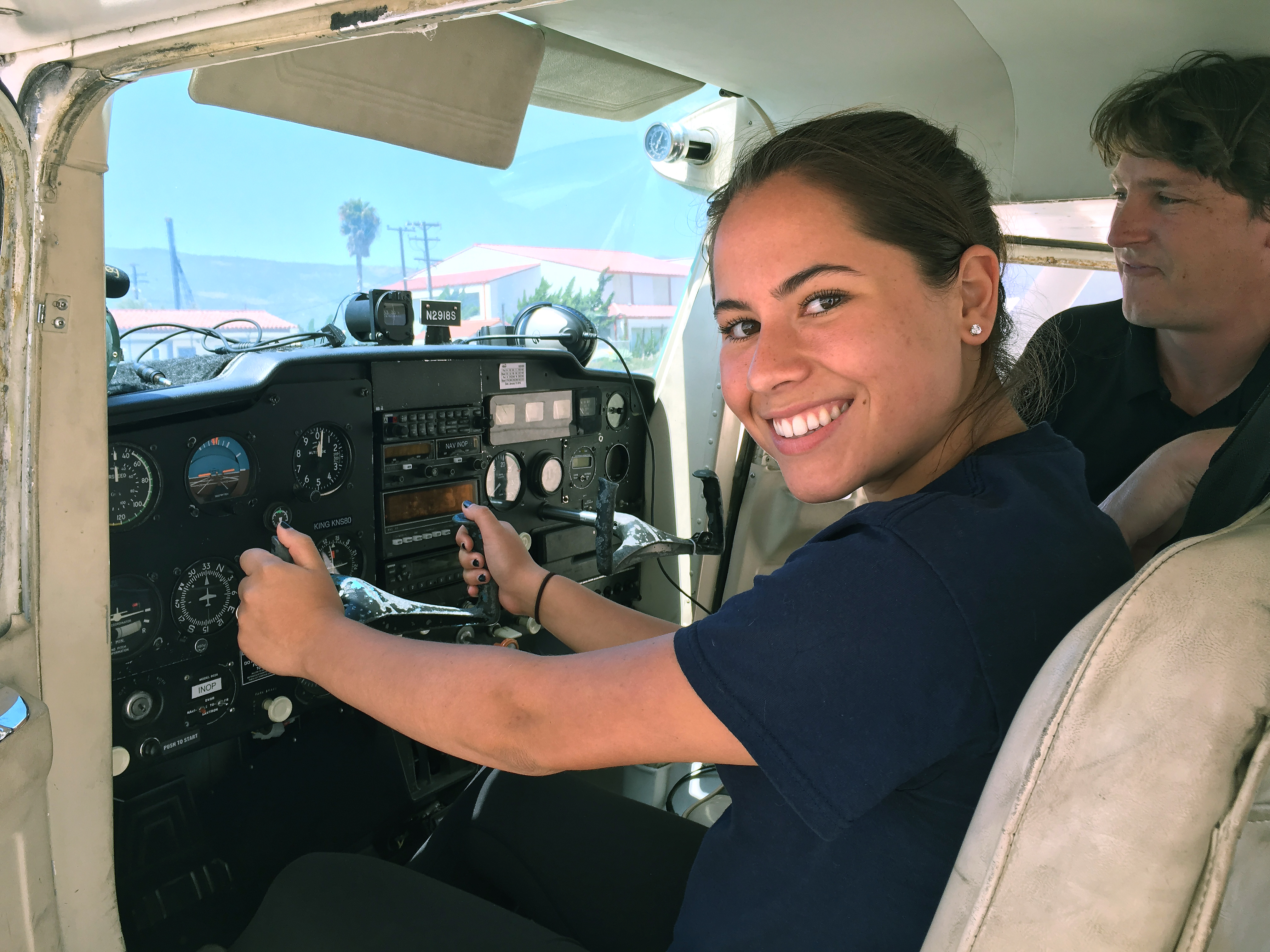 Above All Aviation chief pilot William Peterson, right, supervises Tianna, a California high school student, during A Different Point of View's career day at the Santa Barbara Municipal Airport June 25. Photo courtesy of Lynn Houston.