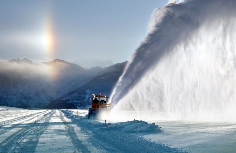 Machinery clears snow from the runway and airport grounds at Telluride, Colorado. Photo by Brett Schreckengost.