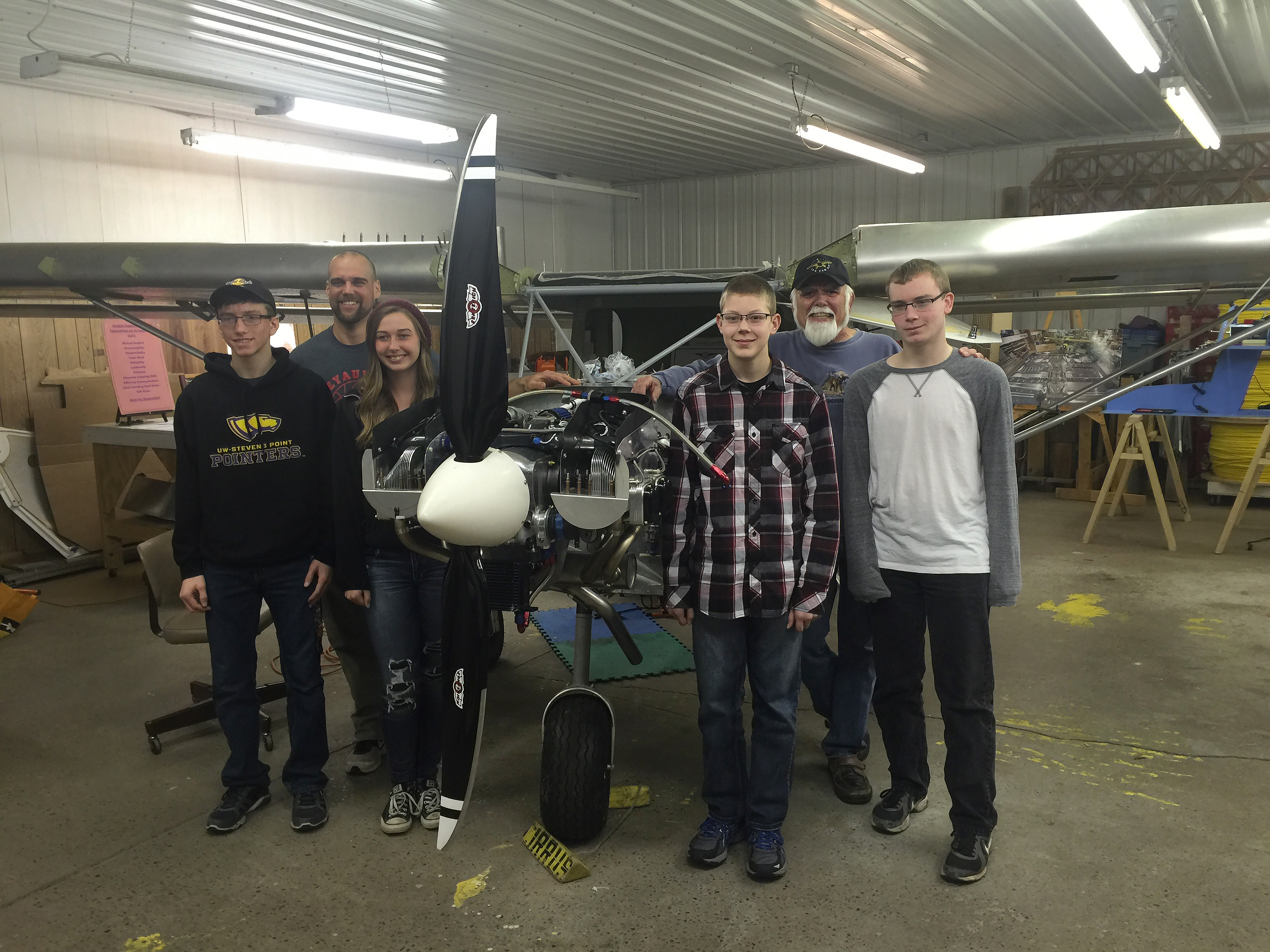 Weyauwega-Fremont High School students Logan Feltz, teacher Mike Hansen, Natasha Stemwedel, Austin Krause, chaperone Jerry Graf, and Derrick Cleaves will travel to Glasair Aviation to build a Sportsman aircraft as winners of the General Aviation Manufacturers Association/Build A Plane Aviation Design Challenge. Photo courtesy of Weyauwega-Fremont High School.